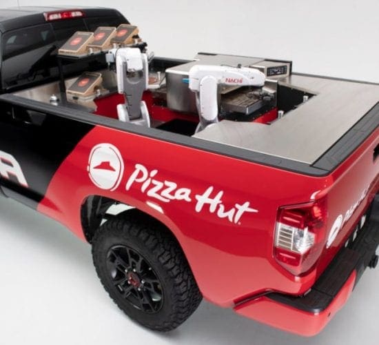 a red and black pickup truck with a pizza kitchen in the back